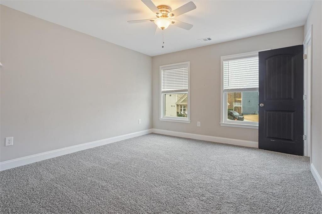 129 Rex Avenue Canton, GA 30114 - Photo 42 of 66 an empty room with windows and fan
