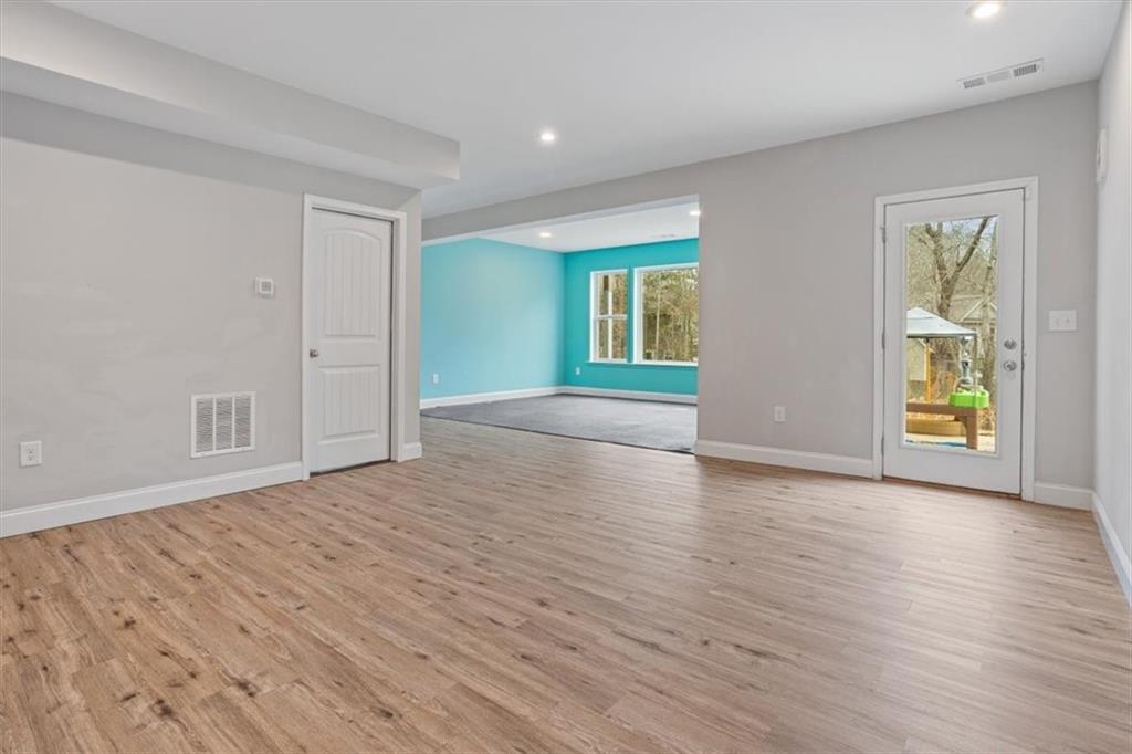 129 Rex Avenue Canton, GA 30114 - Photo 46 of 66 a view of empty room with wooden floor and fan