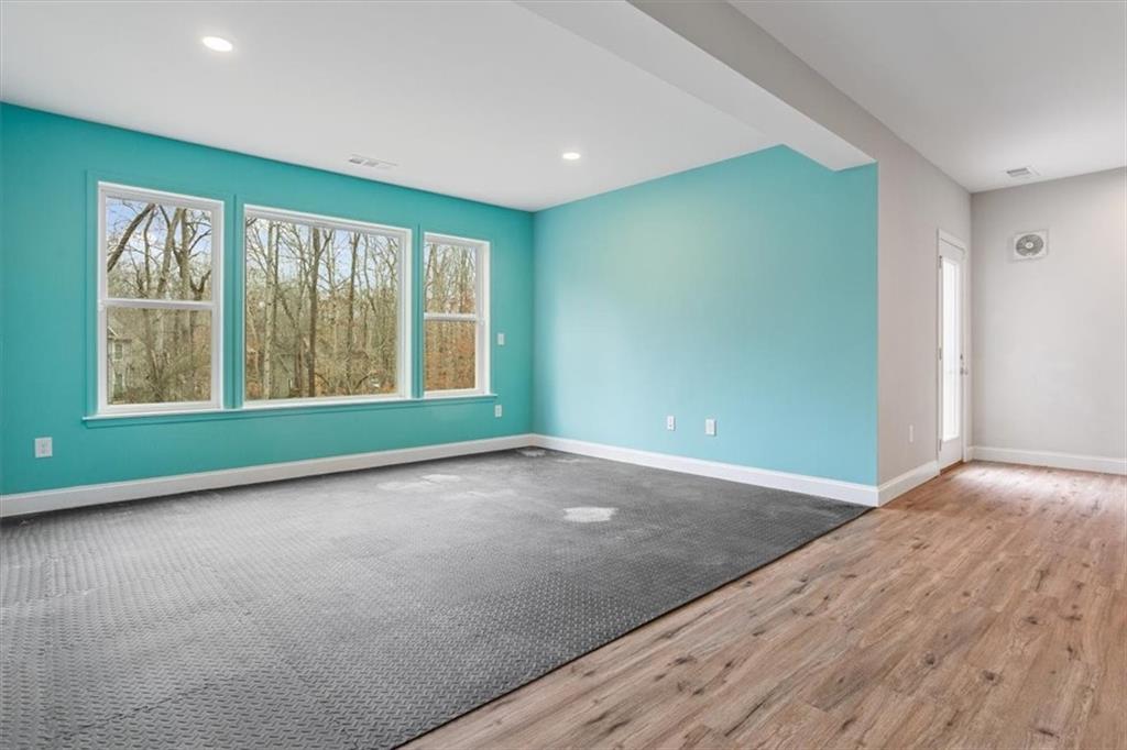 129 Rex Avenue Canton, GA 30114 - Photo 49 of 66 an empty room with wooden floor and windows
