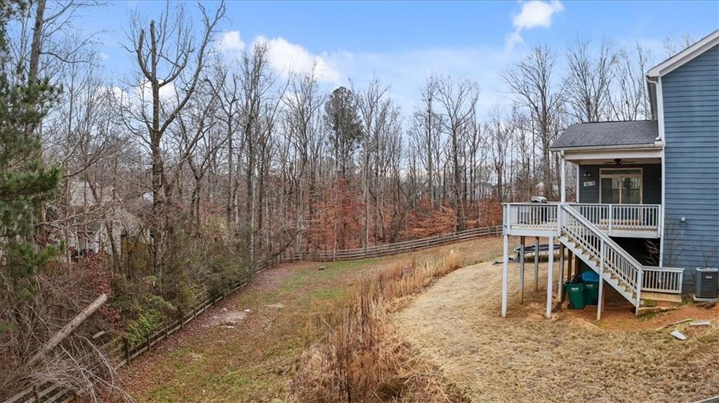 129 Rex Avenue Canton, GA 30114 - Photo 62 of 66 a wooden bench sitting in middle of a forest