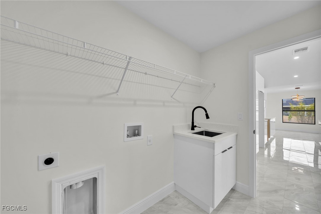 4106 35th Street Southwest Lehigh Acres, FL 33976 - Photo 17 of 38 a view of a bathroom with a sink and mirror