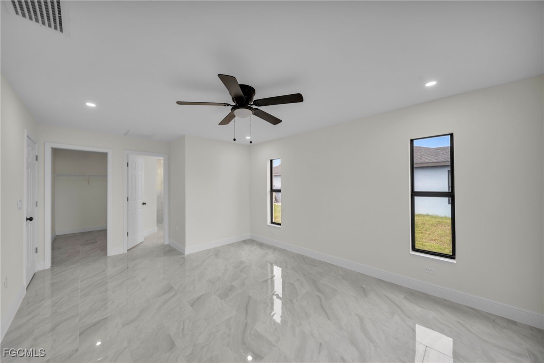 4106 35th Street Southwest Lehigh Acres, FL 33976 - Photo 20 of 38 an empty room with a ceiling fan and window