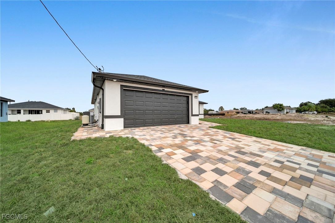4106 35th Street Southwest Lehigh Acres, FL 33976 - Photo 2 of 38 a front view of a house with garden