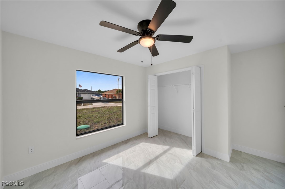 4106 35th Street Southwest Lehigh Acres, FL 33976 - Photo 25 of 38 a view of an empty room with window and wooden floor