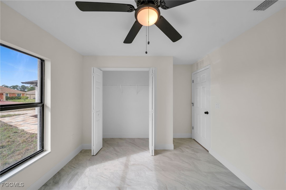 4106 35th Street Southwest Lehigh Acres, FL 33976 - Photo 26 of 38 a view of ceiling fan and window
