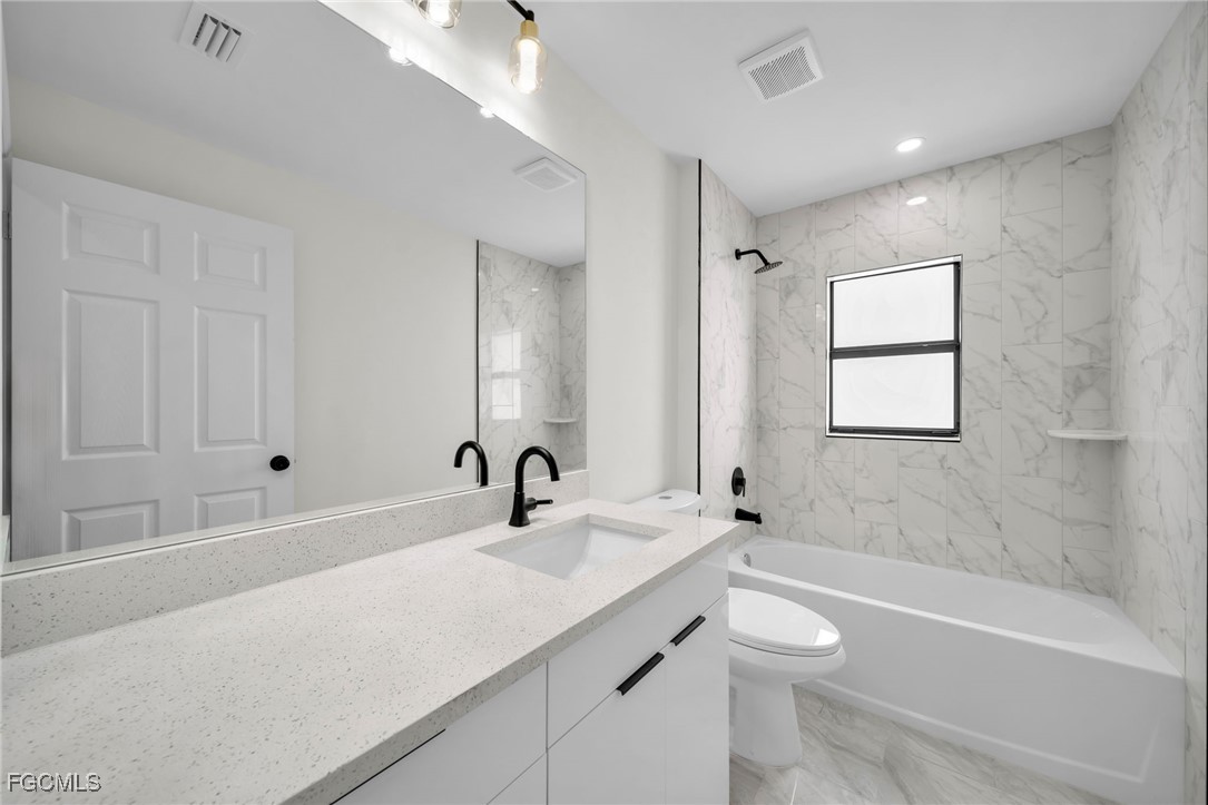 4106 35th Street Southwest Lehigh Acres, FL 33976 - Photo 27 of 38 a bathroom with a sink a toilet and shower