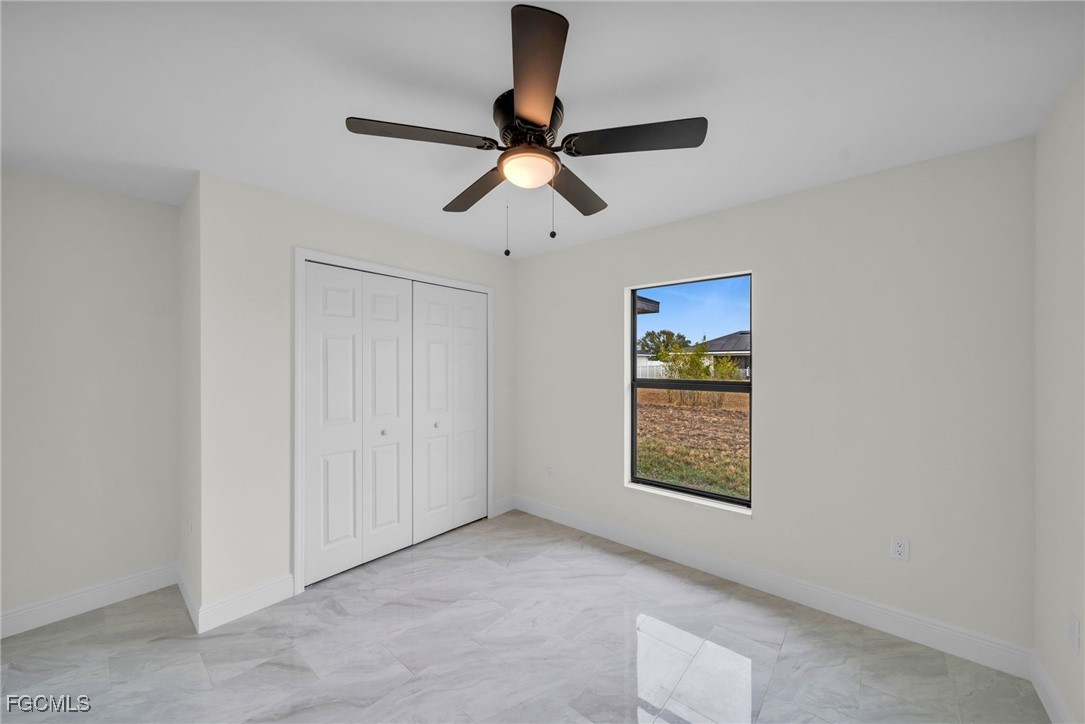 4106 35th Street Southwest Lehigh Acres, FL 33976 - Photo 28 of 38 a view of an entryway and chandelier fan in big room