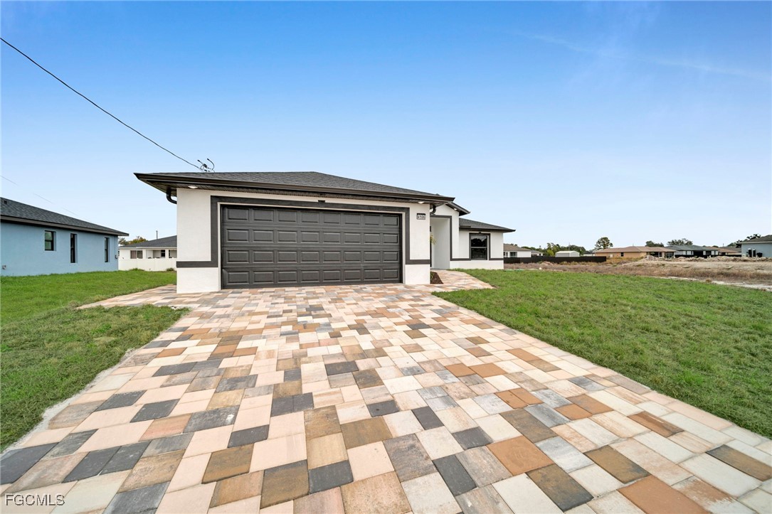 4106 35th Street Southwest Lehigh Acres, FL 33976 - Photo 3 of 38 a front view of a house with a yard