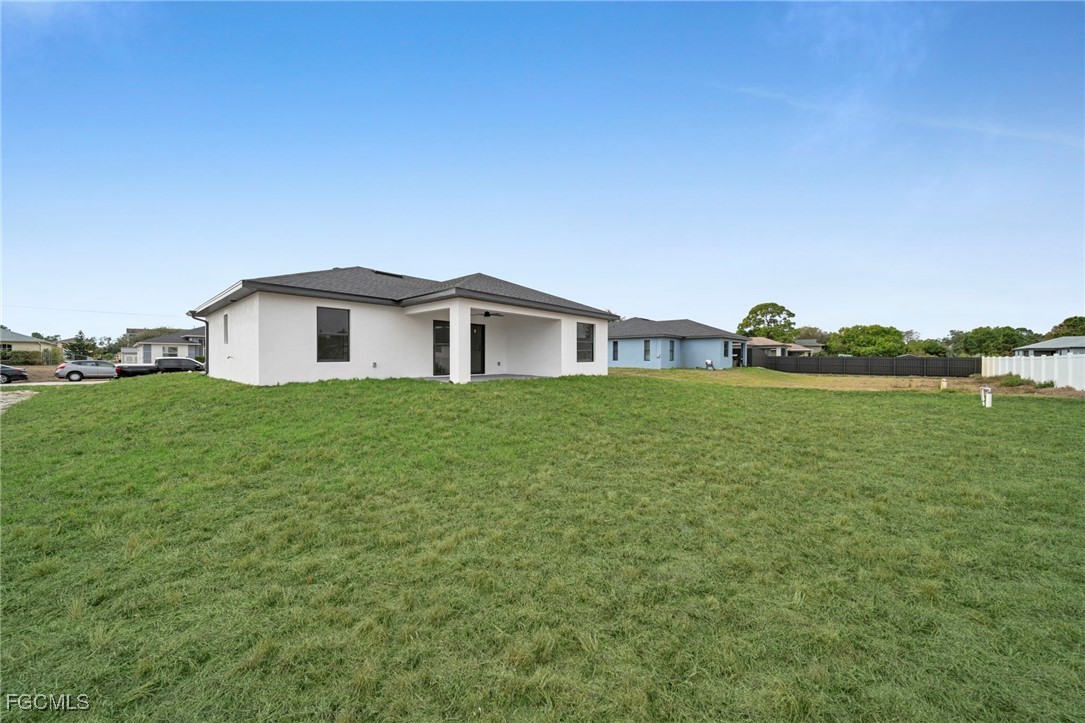 4106 35th Street Southwest Lehigh Acres, FL 33976 - Photo 32 of 38 a view of a house with a yard and a large tree