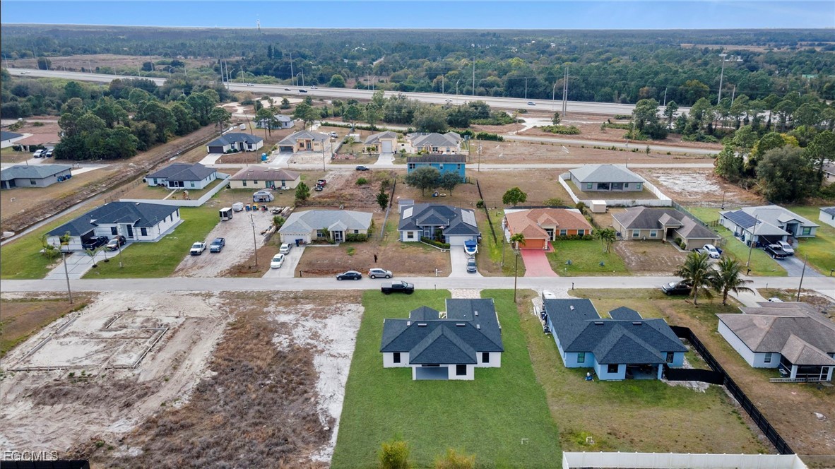 4106 35th Street Southwest Lehigh Acres, FL 33976 - Photo 38 of 38 an aerial view of multiple houses with yard