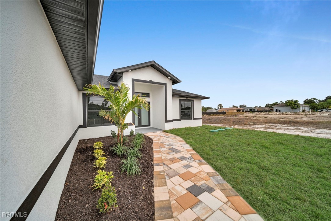 4106 35th Street Southwest Lehigh Acres, FL 33976 - Photo 5 of 38 a front view of a house with garden