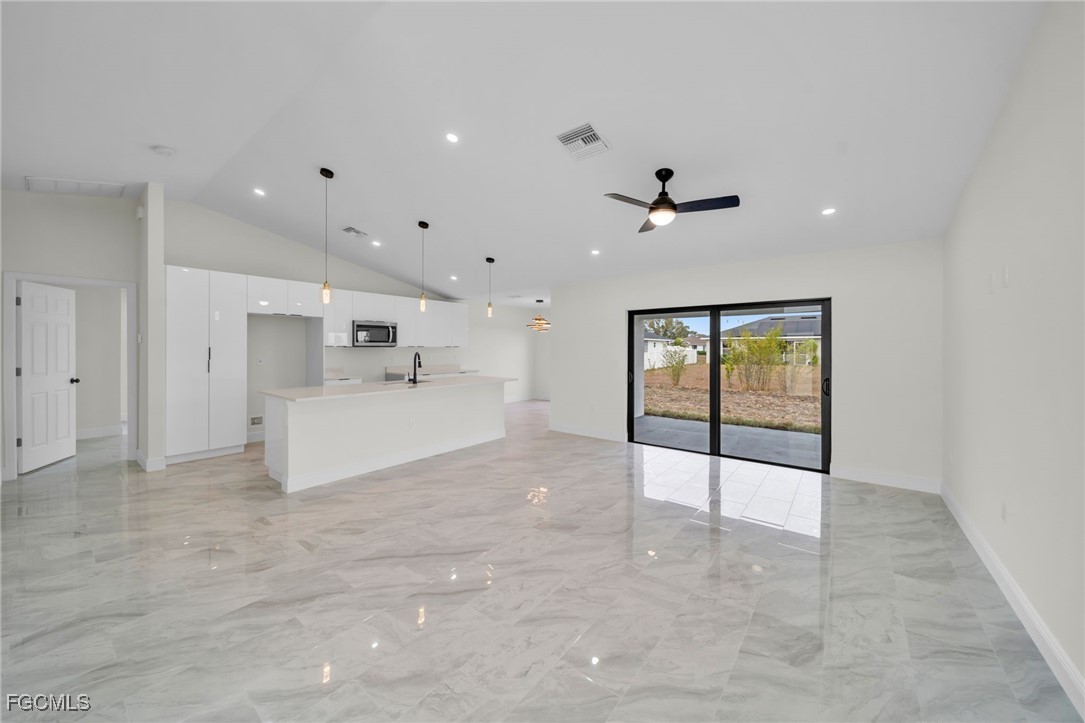 4106 35th Street Southwest Lehigh Acres, FL 33976 - Photo 6 of 38 a view of an empty room with a ceiling fan