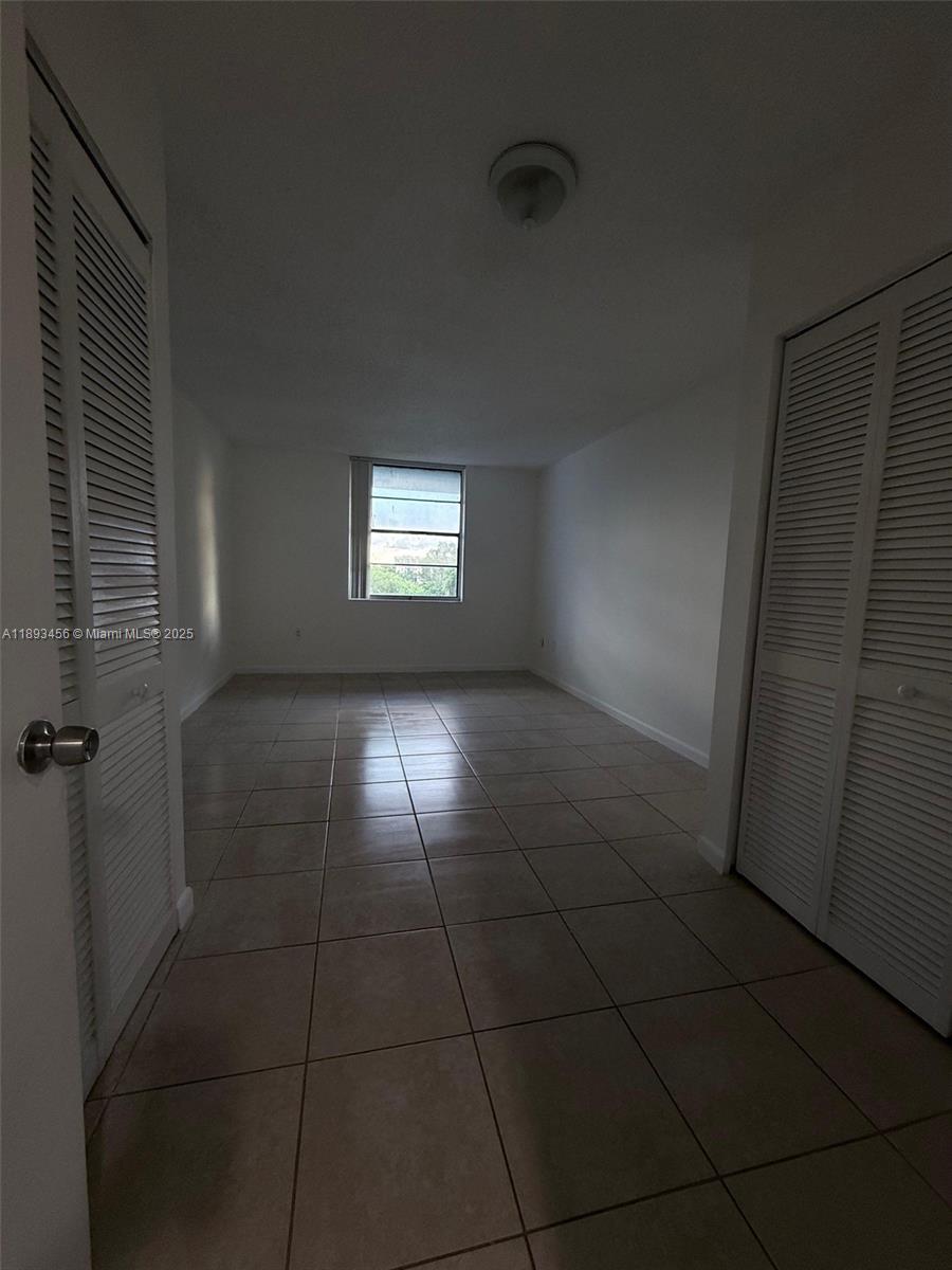 9460 Fontainebleau Boulevard, Unit 429 Miami, FL 33172 - Photo 3 of 5 a view of an empty room with a window