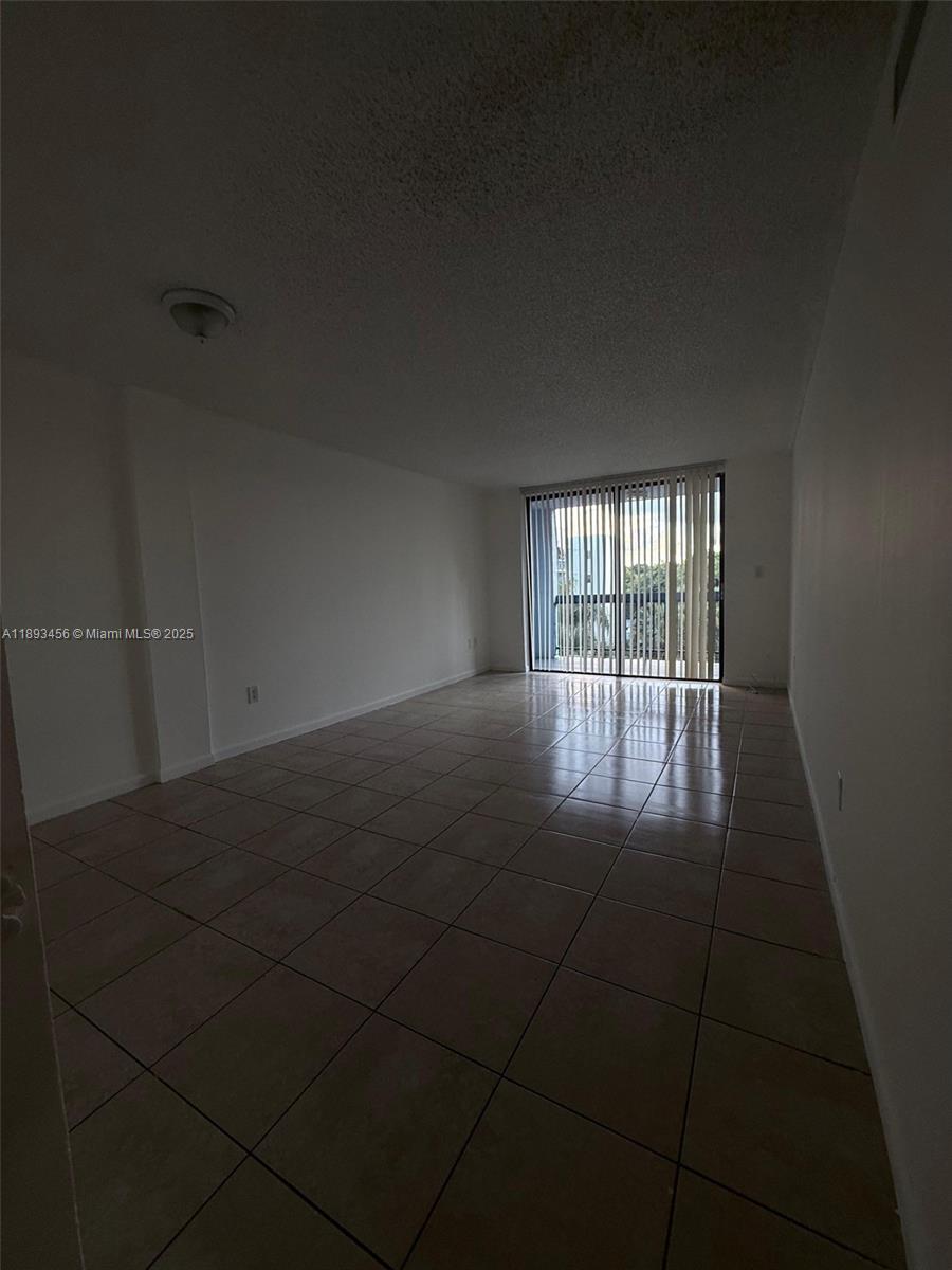 9460 Fontainebleau Boulevard, Unit 429 Miami, FL 33172 - Photo 4 of 5 a view of an empty room with a window