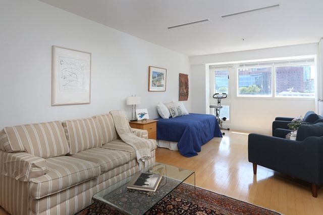 a living room with furniture rug and window