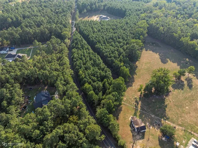 an aerial view of a house with a yard and lake view