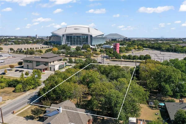 a view of a city with lawn chairs under an umbrella