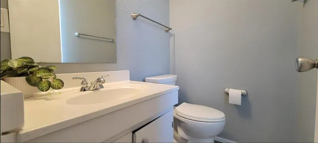 a bathroom with a sink a toilet and mirror
