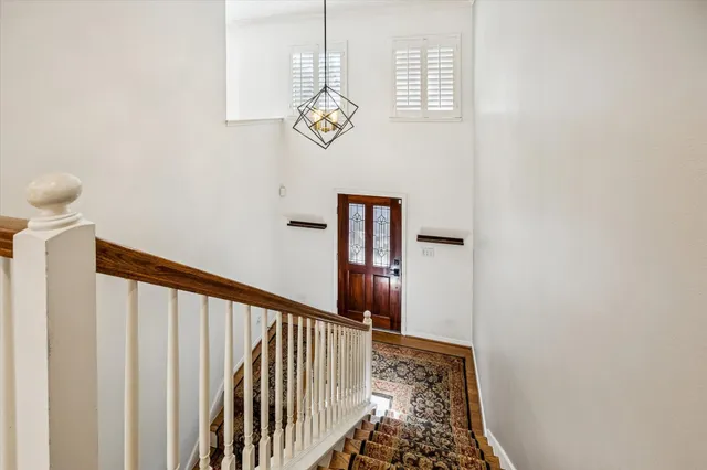 a view of a hallway with wooden floor and a window