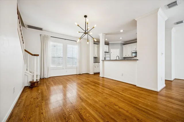 a view of a kitchen with wooden floor and a window