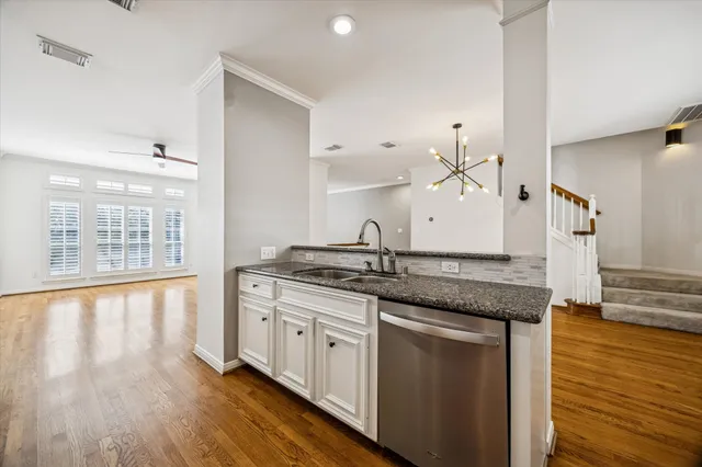 a kitchen with granite countertop a sink and cabinets