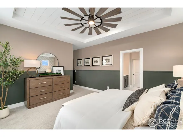 a bedroom with a bed and ceiling fan