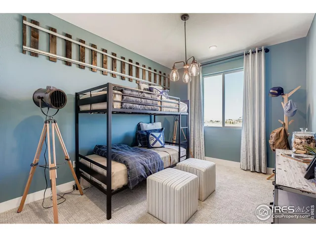 a bedroom with furniture and a chandelier