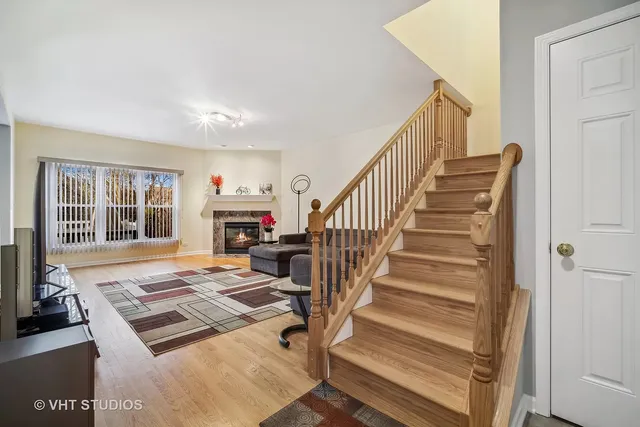 a view of entryway livingroom and hall with wooden floor