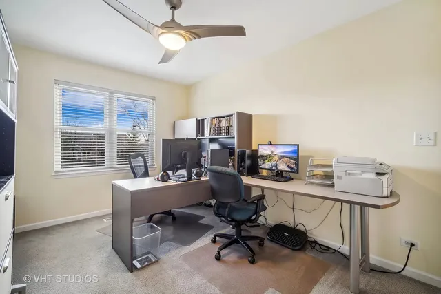 a view of a workspace with furniture and a window