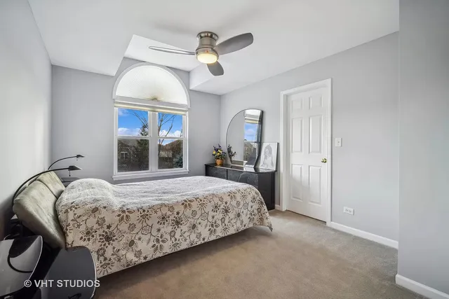 a bedroom with a bed and a mirror