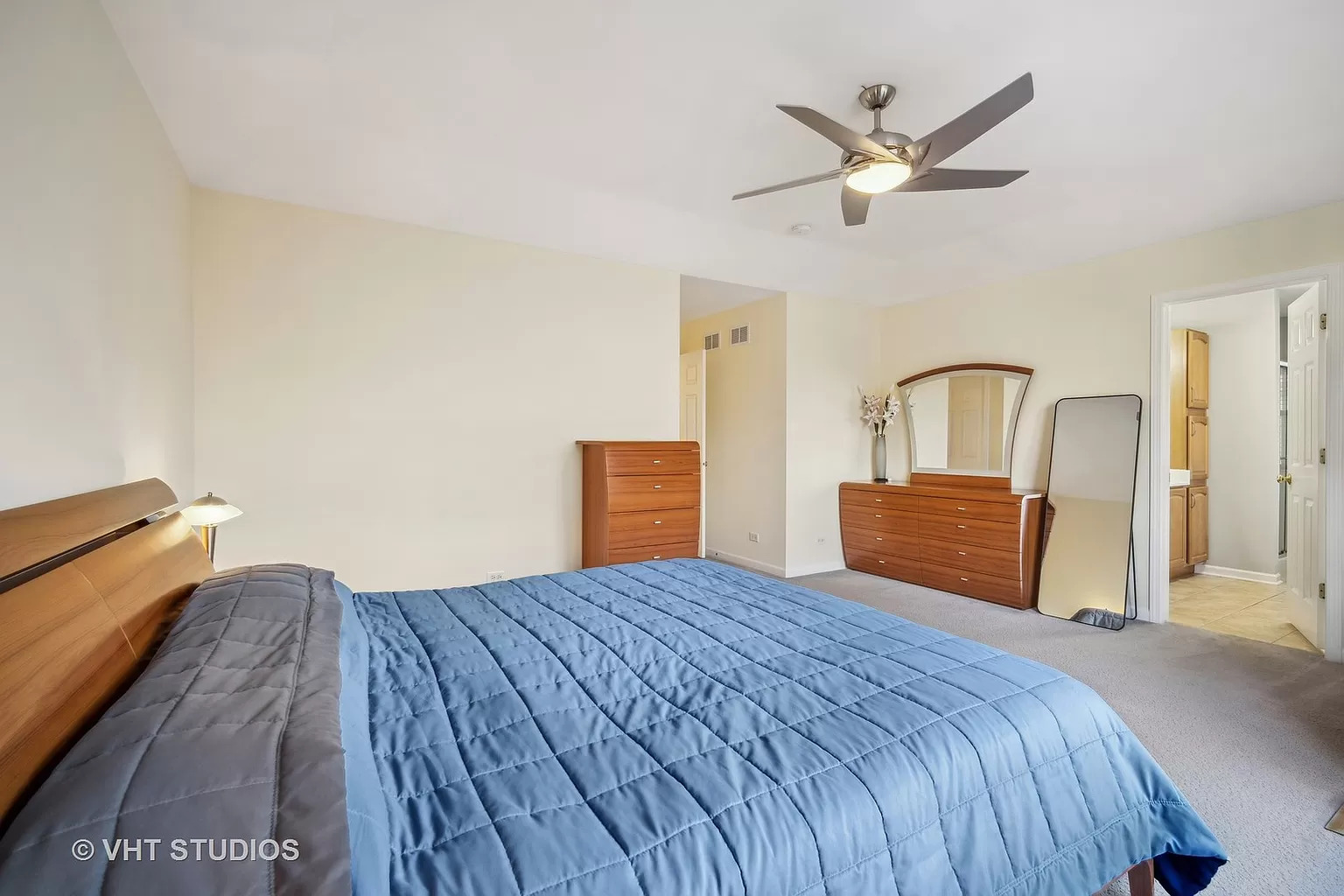 23540 North Melody Lane Lake Zurich, IL 60047 - Photo 24 of 35 a bedroom with a large bed and a chandelier