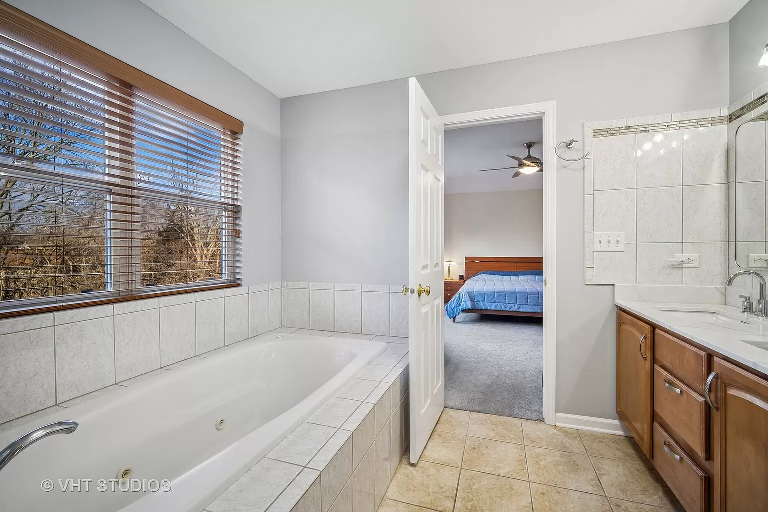 23540 North Melody Lane Lake Zurich, IL 60047 - Photo 27 of 35 a bathroom with a tub a double vanity sink and mirror