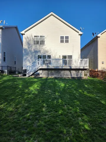 a view of a house with a yard and sitting area