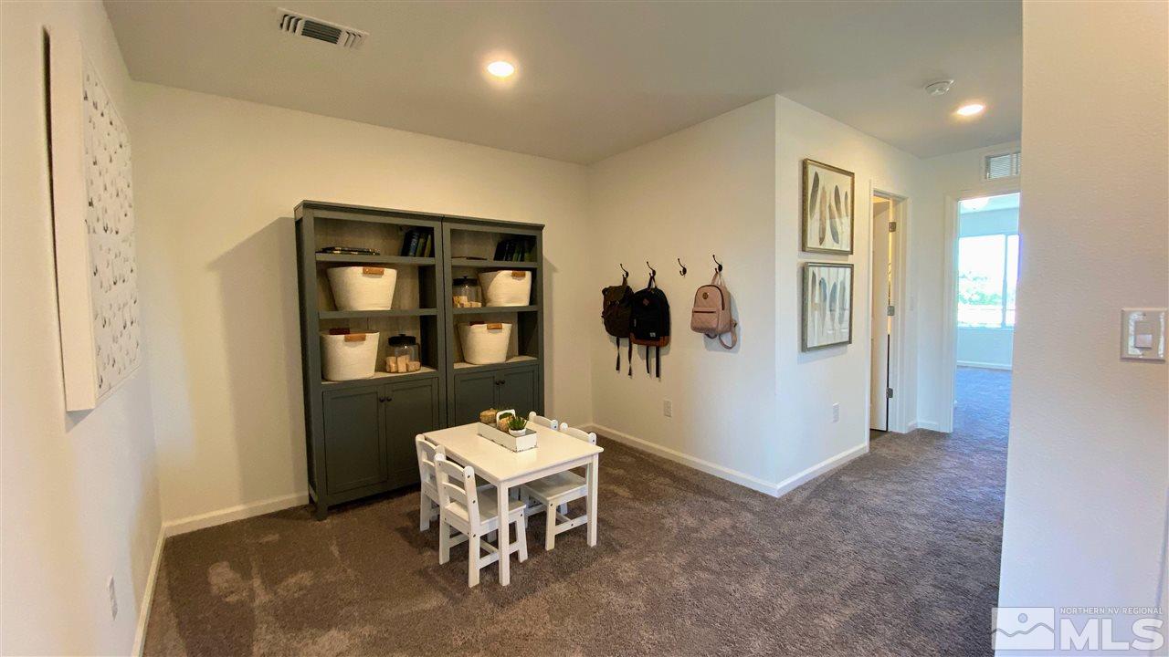 400 Autumn Breeze Circle, Unit LOT #1 Reno, NV 89511 - Photo 16 of 23 a living room with furniture a rug and a wall painting