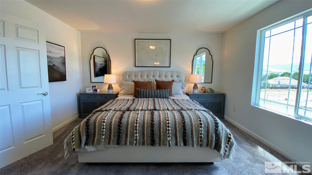 400 Autumn Breeze Circle, Unit LOT #1 Reno, NV 89511 - Photo 18 of 23 a bed sitting in a bedroom next to a window
