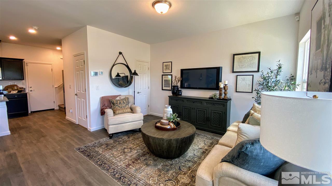400 Autumn Breeze Circle, Unit LOT #1 Reno, NV 89511 - Photo 2 of 23 a living room with furniture a flat screen tv and a fireplace