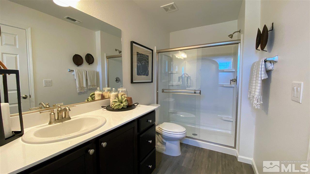 400 Autumn Breeze Circle, Unit LOT #1 Reno, NV 89511 - Photo 21 of 23 a bathroom with a granite countertop sink toilet and shower