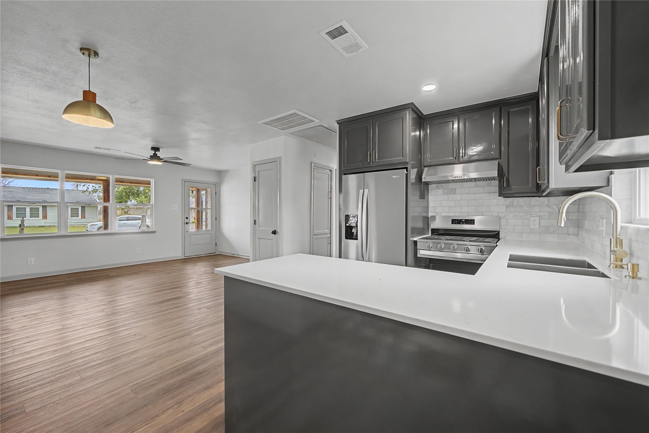 a kitchen with stainless steel appliances a refrigerator sink and cabinets
