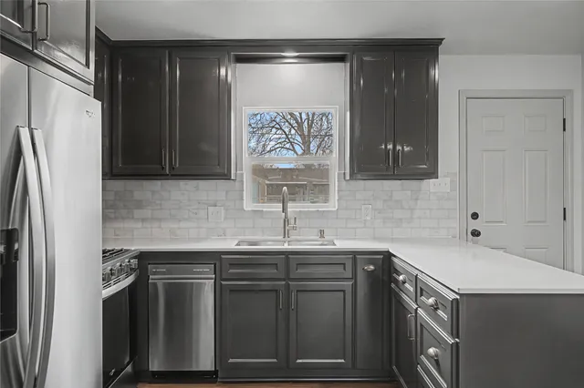 a kitchen with a sink and a refrigerator