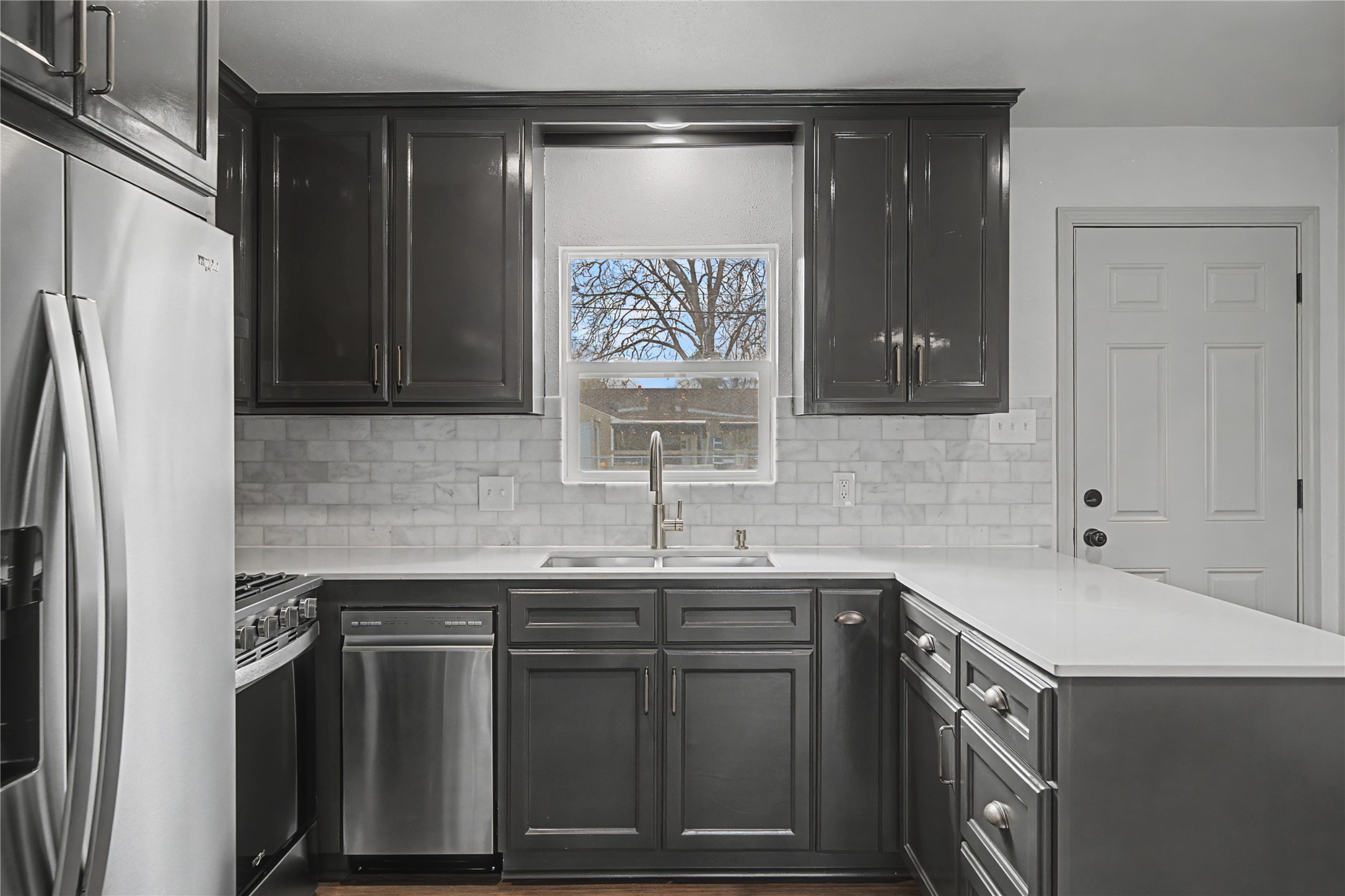 1108 Nottingham Drive Angleton, TX 77515 - Photo 12 of 27 a kitchen with a sink and a refrigerator