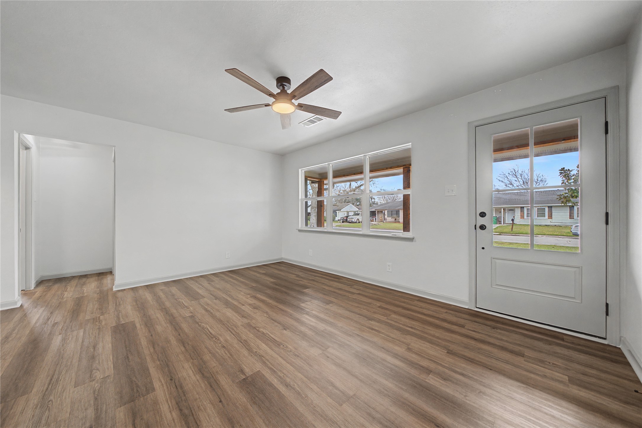 1108 Nottingham Drive Angleton, TX 77515 - Photo 3 of 27 a view of empty room with wooden floor and fan
