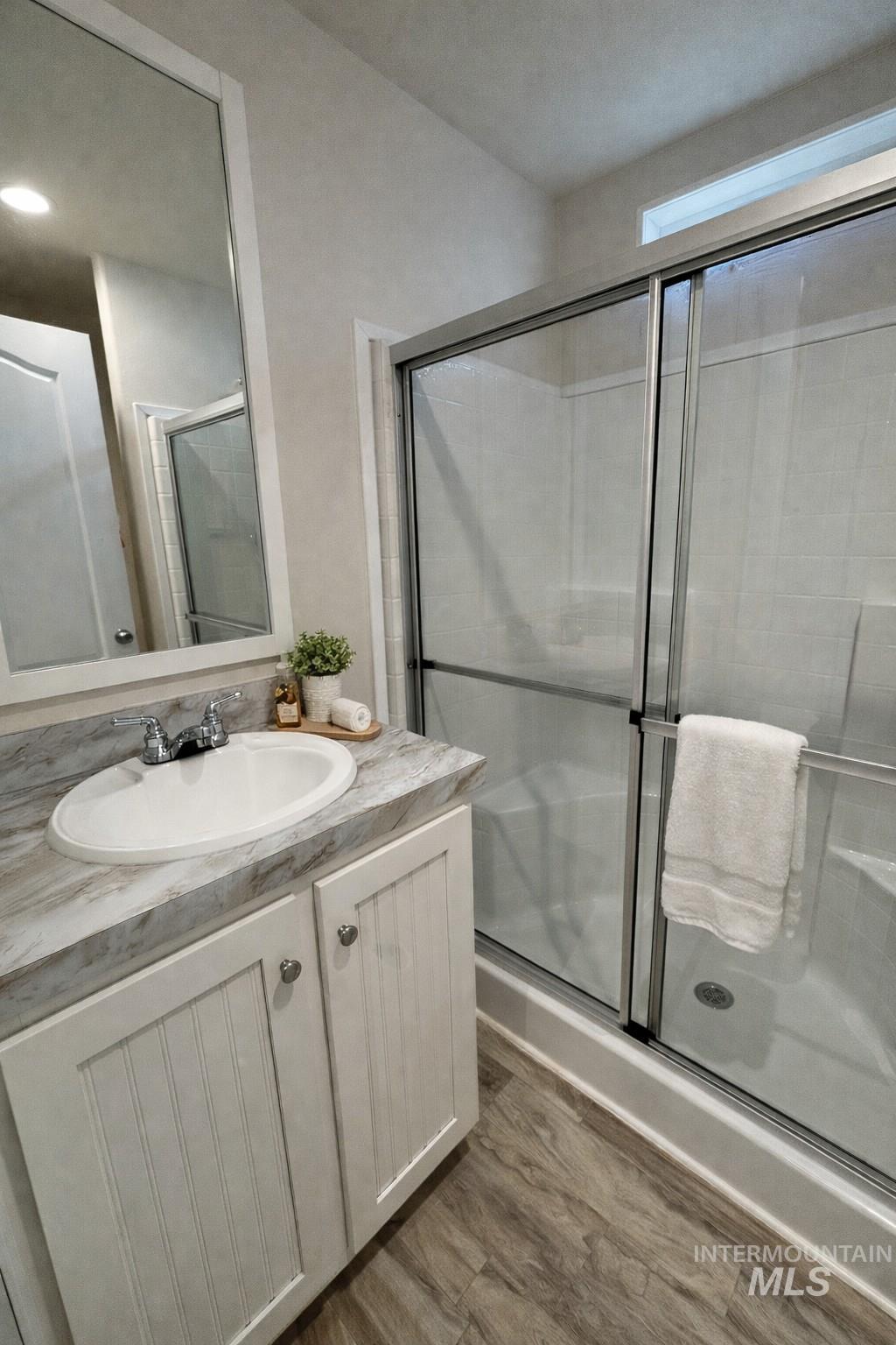 1500 West 7th Street Weiser, ID 83672 - Photo 7 of 10 Bathroom featuring a shower stall, vanity, and dark wood-style flooring