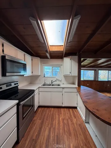 a kitchen with a stove sink and a microwave