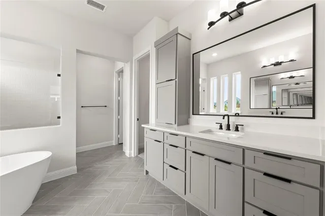 a spacious bathroom with a double vanity sink mirror double and bathtub