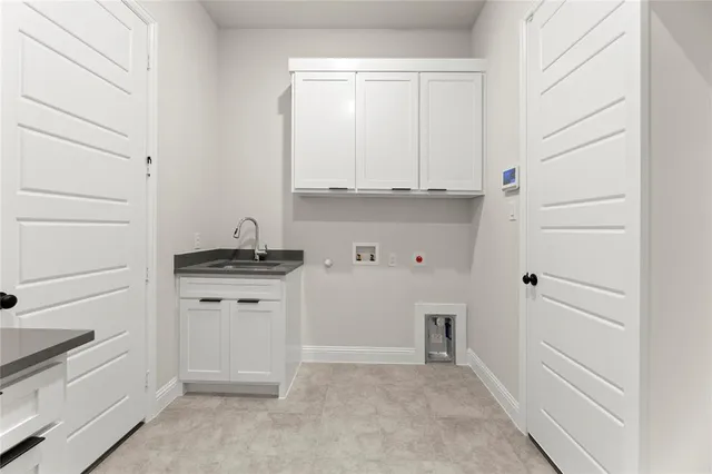 a kitchen with white cabinets and a stove