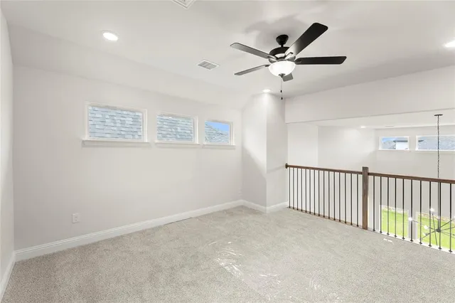 a view of a livingroom with a ceiling fan and window