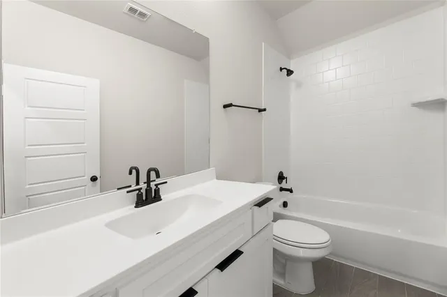 a bathroom with a sink a toilet and a bathtub