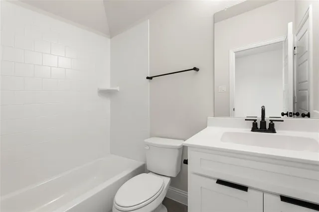a bathroom with a sink toilet vanity and shower