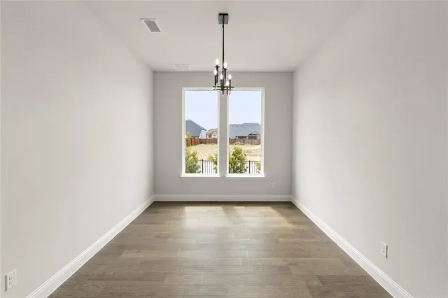 a view of an empty room with windows