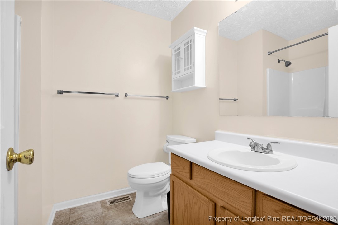 101 2 Hours Court Raeford, NC 28376 - Photo 14 of 30 a bathroom with a sink toilet and vanity